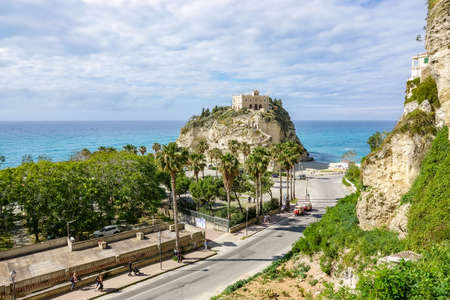 Amazing tropical panoramic view of turquoise bay, sandy beach, green mountains and plants, blue sky, white clouds background, Capo Vaticano rock platform, Calabria, southern Italy.の写真素材