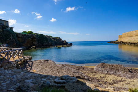 Amazing tropical panoramic view of turquoise bay, sandy beach, green mountains and plants, blue sky, white clouds background, Capo Vaticano rock platform, Calabria, southern Italy.の写真素材