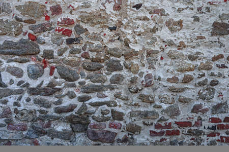 Old stone wall, brick wall, structure. old broken bricks, cement joints closeup. crumble with age. construction, repair. concept of destruction, decline. High quality photoの写真素材