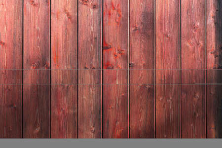 Wooden boards with wood texture for background. Dark reddish plank wall. High quality photoの写真素材