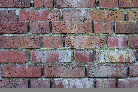 Old brick wall, brick wall, structure. old broken bricks, cement joints closeup. crumble with age. construction, repair. concept of destruction, decline. High quality photoの写真素材