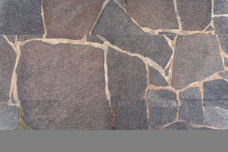 Stone pavement with abstract pattern closeup. crumble with age. construction, repair. concept of destruction, decline. High quality photoの写真素材