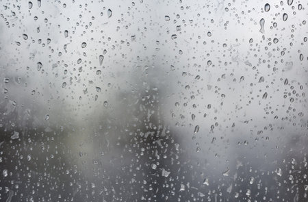 Rain drops on window glass. Raindrops on window glass background.の素材