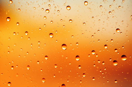 Drops of rain on the window, orange background. Shallow DOFの素材