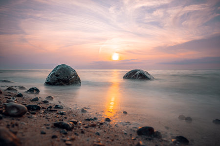 Beautiful seascape with rocks on the beach at sunset.の写真素材