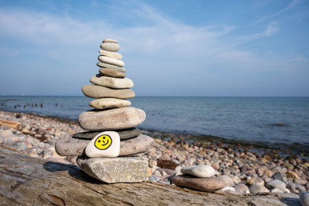 Pile of zen stones with smiley face on the beachの写真素材