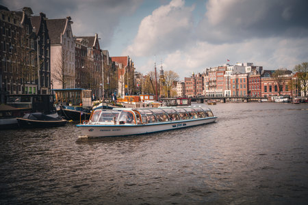 Tourist boat on the canals of Amsterdam.の写真素材