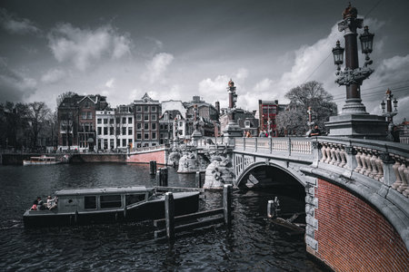 Amsterdam canal view with bridge and boats, Holland, Netherlands.の写真素材
