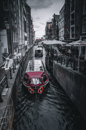 Amsterdam canals with boats and gondolas, Netherlands.の写真素材