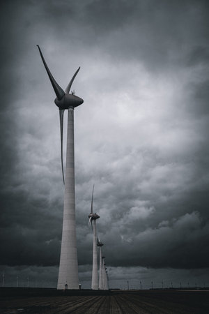 An image of wind turbines in a stormy day.の写真素材