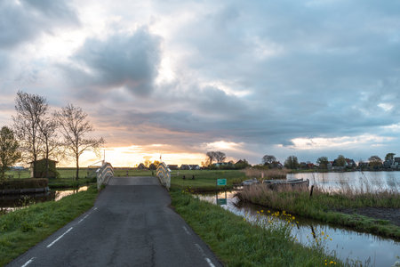 Sunset over a canal in the countryside of North Holland, Netherlandsの写真素材