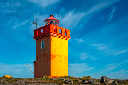 Red lighthouse on the coast of Atlantic ocean in Tromso, Norwayの写真素材