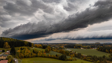 Huge squall cloud with storm and heavy rain. Roll cloud or arc of a severe storm in autumn over the...