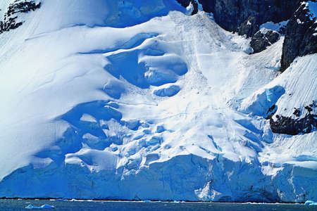 This is summer in Pleneau Island, Antarctic Peninsula. There are penguins, whales, icebergs, ice floes, glaciers, oceans, radioactive clouds and sunlight.の写真素材