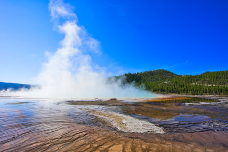 Old Faithful Geyser Eruption, Wonderful natural landscape. Yellowstone National Park is famous for its rich wildlife species and geothermal resources.の写真素材