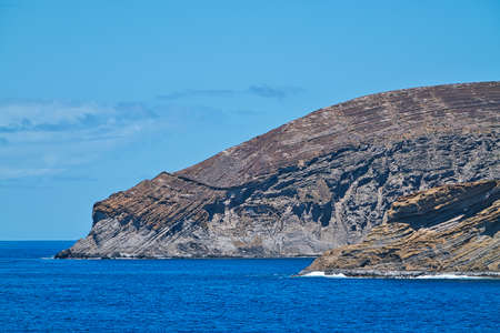 One of the small islands in the Hawaiian Islands. The view from the cruise ship. June 2019.の写真素材
