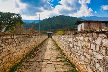 Stone-paved alleys. Walls made of earth and white stone blocks. A corner of a Buddhist temple, Bhutan. November 2019の写真素材
