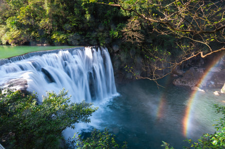 Turquoise streams, green bushes, waterfall views. R'ainbow over the stream, Refreshing natural landscape. Taiwanの写真素材