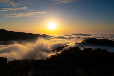 Layers of surging clouds are very spectacular. Sunset behind the mountains. The sea of clouds...