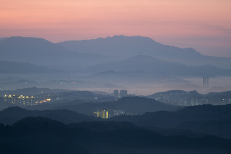 A village surrounded by mountains and sea. The blue sky and colorful clouds. Jiufen at dusk. Ruifang District, New Taipei City, Taiwanの写真素材