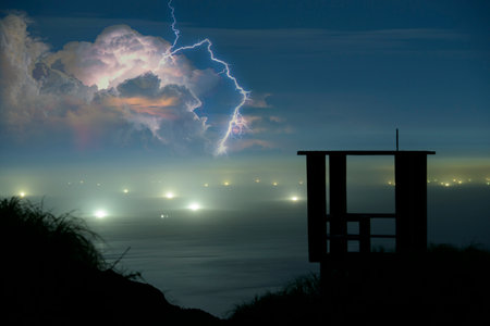 Abandoned equipment at a radar station. Lightning and fishing boat lights. Viewing platform of...