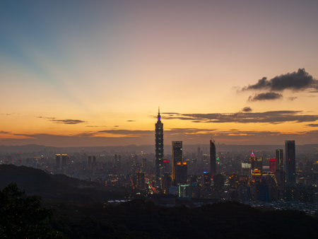 Urban Splendor at Night: Watching Dynamic Clouds Above a Dazzling Cityscape. View of Taipei city from the Four Beasts Mountain Trail, Taiwanの写真素材