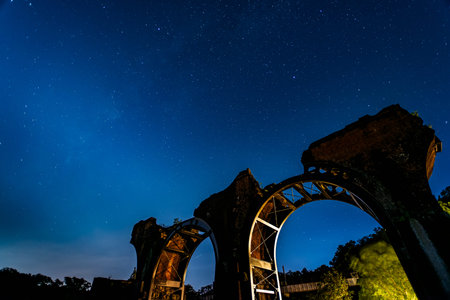 Autumn night, Milky Way in the sky. It looks unobtrusive and unobtrusive. Longteng Broken Bridge is a historic roadside attraction in the rolling hills.の写真素材