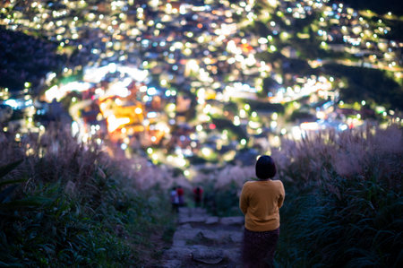 Overlooking the lively and colorful valley villages at night. Jiufen, Taiwan. Hike the mountain trails and admire miscanthus flowers and villages. Ruifangt.の写真素材
