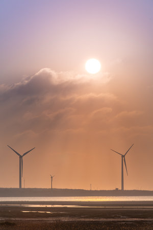 Offshore wind farms are great for enjoying the scenery and watching the sunset. Gaomei Windmill Avenue. Taichung Harbor Wind Power Station. Taiwan.の写真素材