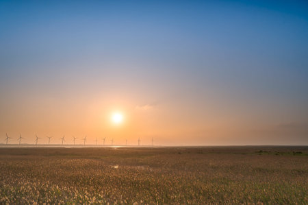 Offshore wind farms are great for enjoying the scenery and watching the sunset. Gaomei Windmill Avenue. Taichung Harbor Wind Power Station. Taiwan.の写真素材