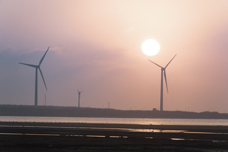 Offshore wind farms are great for enjoying the scenery and watching the sunset. Gaomei Windmill Avenue. Taichung Harbor Wind Power Station. Taiwan.の写真素材