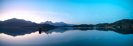Before sunrise, the view of the dock with lakes and mountains. Sun Moon Lake is one of Taiwan's...