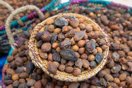 Detailed view of brown argan nuts in traditional basket. Morocco's natural skin care product, Essaouira, Morocco.の写真素材