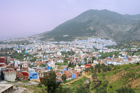 Vivid blue-painted buildings of Chefchaouen cascade down Moroccan hillsides. A unique blend of tradition and color, in Chefchaouen, Morocco.の写真素材