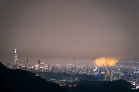 A breathtaking night view of Taipei City skyline with fireworks. The city lights and firework display create a stunning visual spectacle. Taipei, Taiwan.の写真素材