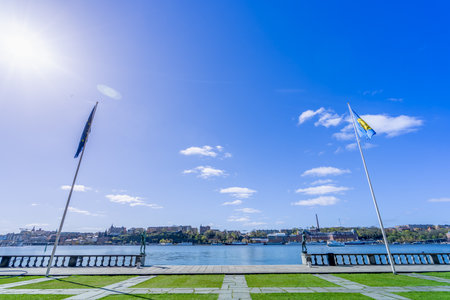 A breathtaking panoramic view of Lake Malaren from the grounds of Stockholm City Hall. The calm waters of the lake reflect the blue sky and the city skyline.の写真素材