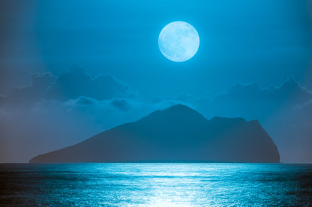 A serene night scene of the ocean with gentle waves, featuring a mesmerizing moonrise behind the...