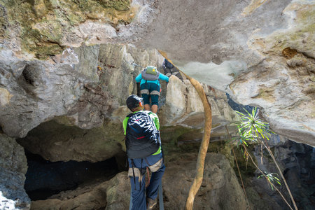 Bemaraha National Park, Madagascar - August 28, 2024: Tourists navigate through narrow limestone...