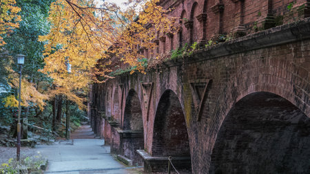 The historic brick Suikaku Aqueduct at Nanzen-ji Temple framed by autumn foliage. A unique blend of Romanesque architecture and Japanese landscape. Nanzenji Temple, Kyoto, Japan.の写真素材