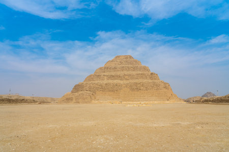 The Step Pyramid of Zoser rises from the desert sands, a monumental tribute to ancient Egyptian ingenuity. A vast, timeless landscape.の写真素材
