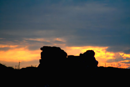 Silhouette of rocks at Laomei Green Reef against a vibrant sunset. Captures the contrast and beauty of the coastal landscape. Shot in Shimen, New Taipei City. Taiwan.の写真素材