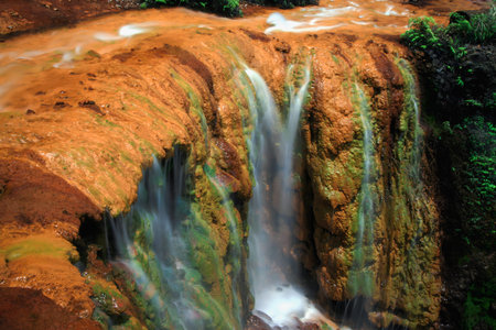 Close up shot of Golden Waterfall in Taiwan, showcasing mineral deposits and flowing water. Jiufen, New Taipei, Taiwan.の写真素材