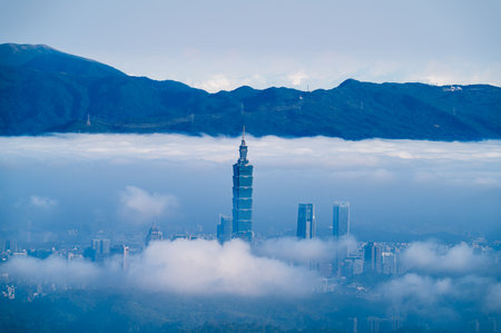 A spring morning view from Lion's Head Mountain in Xindian, Taiwan. Taipei's skyline is covered by a...