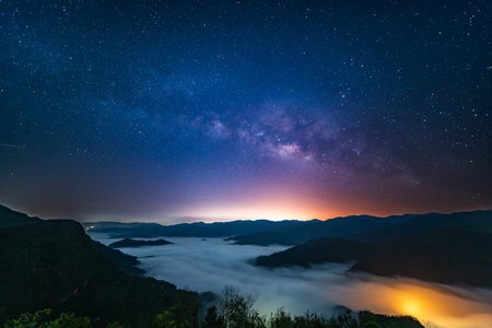 Magnificent view of the Milky Way starry sky and sea of â€‹â€‹â€‹â€‹clouds above...