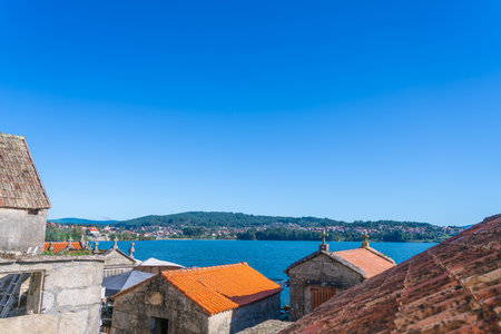 This image captures the picturesque coastal town of Combarro, Spain, showcasing traditional Galician...