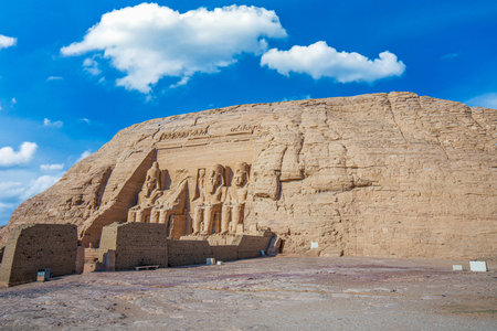 View of colossal seated statues carved into the cliffside at the historic rock temples in Aswan under clear sky. Abu Simbel, Egypt.の写真素材