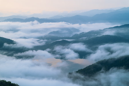 Peaceful spring morning in Taiwan's Xindian Mountain, with fog drifting over a quiet reservoir catchment.の写真素材