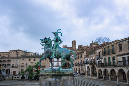 The equestrian statue of Francisco Pizarro dominates the historic Plaza Mayor in Trujillo Spain, surrounded by traditional Spanish architecture.の写真素材