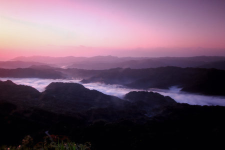Sunrise casting a pink glow over Wufen Mountain in New Taipei City Taiwan, captured in spring 2012...
