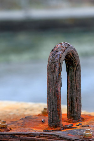 Close-up of a weathered rusty anchor at Longgang in Houlong, Miaoli, Taiwan, against a blurred...